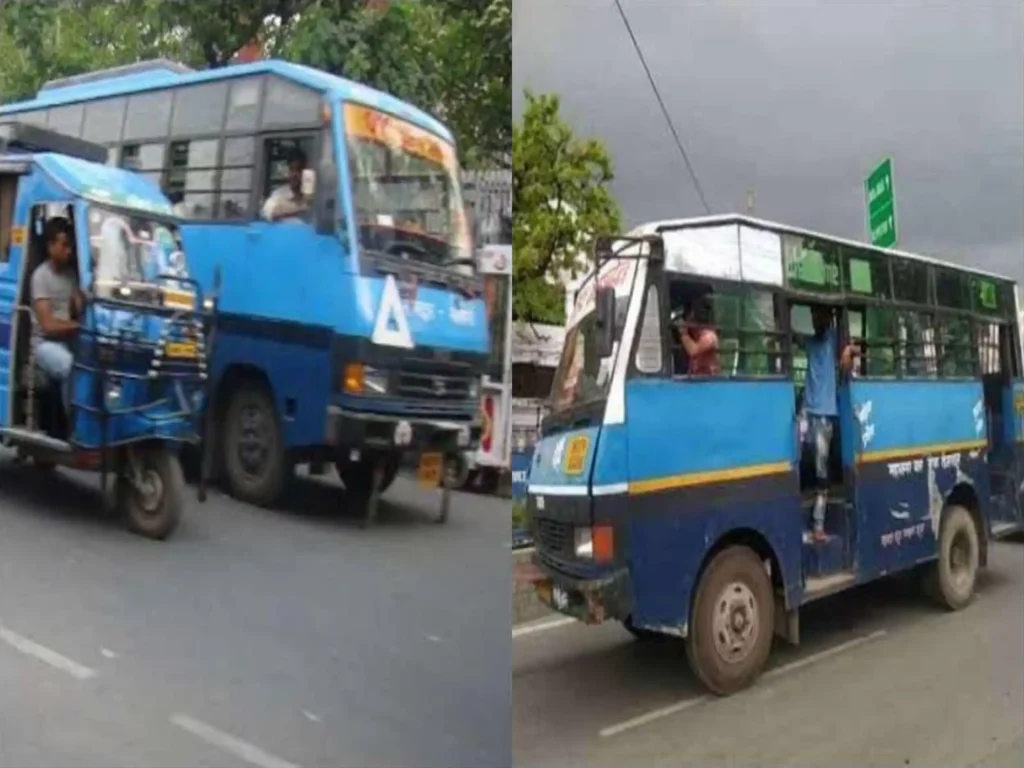 देहरादून की पुरानी नीली सिटी बस सड़क पर चलती हुई दिखाई दे रही है।