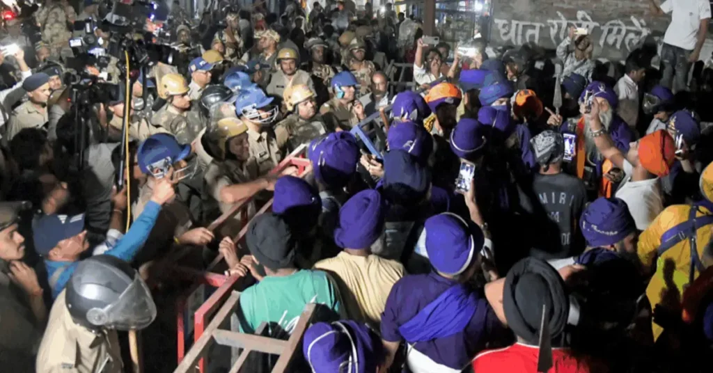 Night-time scene showing Nihang group members near police barricading at the Uttarakhand-Himachal Pradesh border checkpoint.