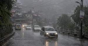 Vehicles moving through heavy rainfall on a hill road in Uttarakhand amid worsening weather conditions.