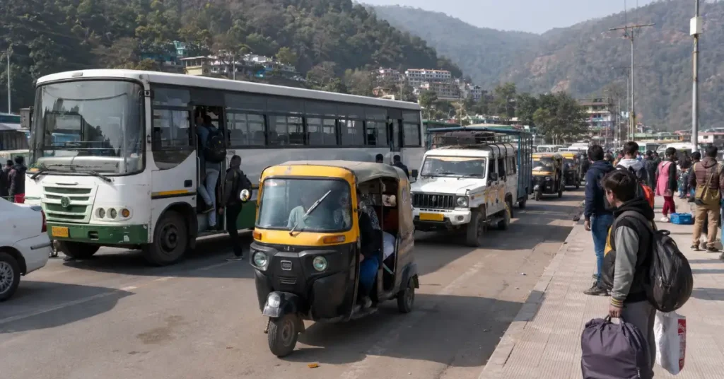 Public transport vehicles including a bus, auto-rickshaw and utility vehicles operating in Uttarakhand.