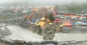 The Badrinath temple area beside the fast-flowing Alaknanda River during continuous monsoon rainfall in Uttarakhand.