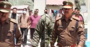 Uttarakhand Police personnel escort suspended temple committee employee Pramod Nautiyal following his arrest in the Badrinath Dham donation case.