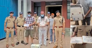 Haridwar Police personnel with arrested suspects and seized counterfeit currency printing equipment during an interstate fake currency investigation.