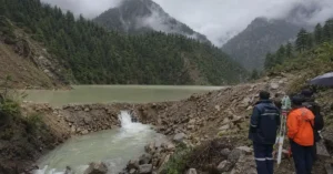 Officials monitoring a temporary artificial lake in Harsil, Uttarkashi, during the monsoon season.