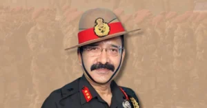 Portrait of Lieutenant General Gajendra Joshi with a blurred Indian Army parade background following his appointment as Chairman of the Uttarakhand Public Service Commission.