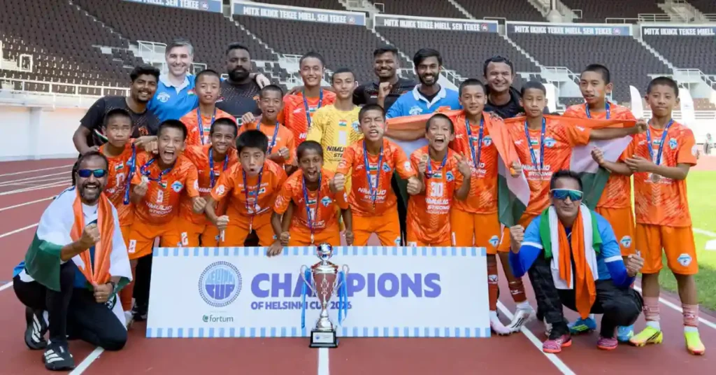 Minerva Academy Under-12 players celebrate with the Helsinki Cup 2026 trophy after defeating HJK in the final in Finland.