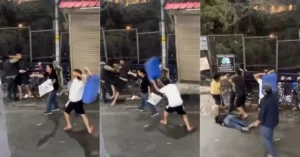 Video grab showing a tourist allegedly attacking local residents with a plastic crate during a clash on Mussoorie Mall Road.