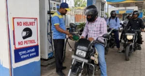 A helmeted two-wheeler rider refuelling at a petrol pump under the No Helmet No Petrol rule in Nainital.