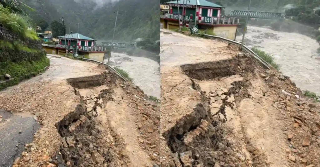 A damaged stretch of road with severe edge erosion in Narayanbagad, Chamoli, after heavy monsoon rainfall, with the Alaknanda River flowing alongside.