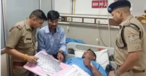 Uttarakhand Police officers meet a person injured in the Raipur firing incident at the hospital