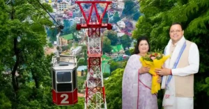 Chief Minister Pushkar Singh Dhami and Bhawna Mehra with a representative ropeway installation highlighting the proposed Ranibagh-Bhimtal ropeway project in Uttarakhand.