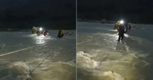 SDRF personnel conduct a rope-assisted rescue operation after people became stranded in a swollen river near Santla Devi Temple in Dehradun.
