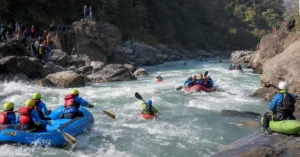 Professional rafters and kayakers navigating the whitewater rapids of the Tons River during an international adventure sports competition.
