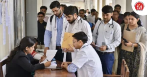 Medical officers and specialist doctor candidates submitting documents during an NHM walk-in recruitment process in Uttarakhand.