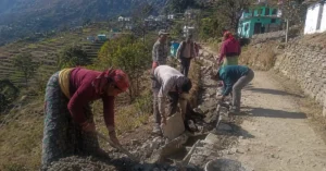 Rural workers engaged in community development work in a Uttarakhand village under a rural employment programme.
