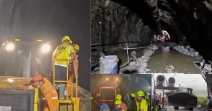 Rescue personnel working with equipment inside and around a water-filled tunnel during a rescue operation in Chamoli