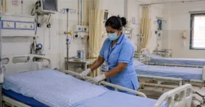 Nurse preparing hospital beds for H1N1 patient care in Dehradun