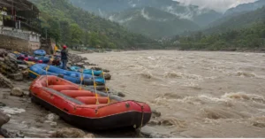 Rafting boats waiting on the Ganga riverbank in Rishikesh during high water levels
