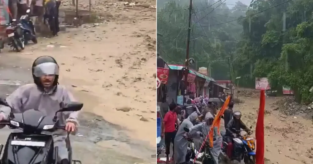 Mud and debris cover the road near Tilwara in Rudraprayag as people and two-wheelers gather after a landslide triggered by heavy rainfall.