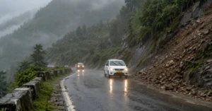 Heavy rain and low visibility on a mountain road in Uttarakhand during the monsoon.