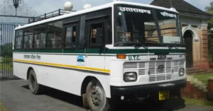 A Uttarakhand Transport Corporation (UTC) Roadways bus parked outside a transport facility in Uttarakhand.