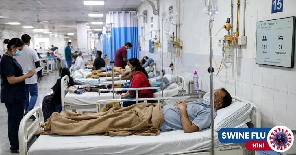 Hospital ward in Dehradun with patients receiving treatment for H1N1 and healthcare staff attending to them.