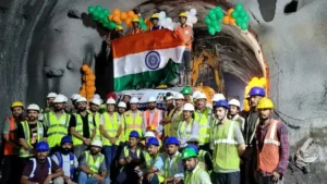 Railway workers gathered inside a tunnel after a breakthrough during the Rishikesh-Karnaprayag rail project