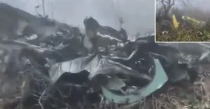 Close-up view of reported helicopter wreckage near Joshimath, Uttarakhand, showing twisted metal, damaged aircraft components and debris scattered across a mountainous crash site.